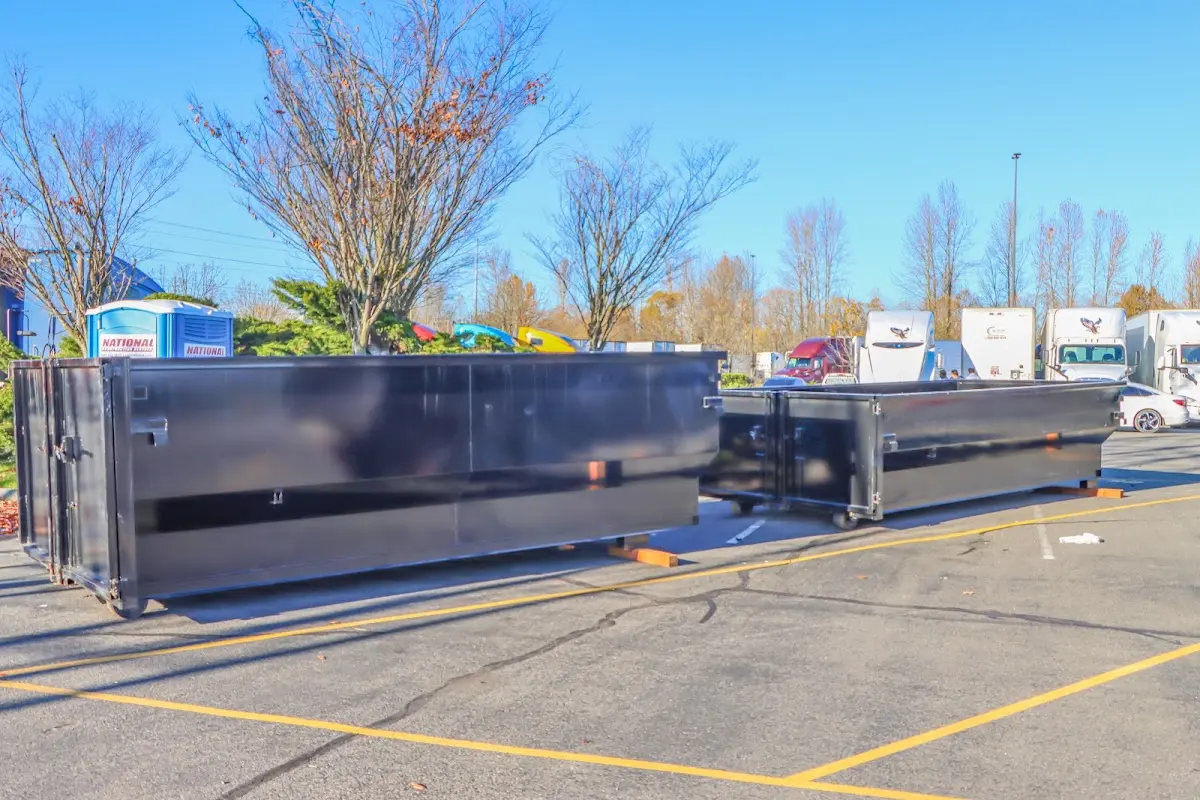 Professional dumpster rental service with roll-off container on residential driveway in Show Low